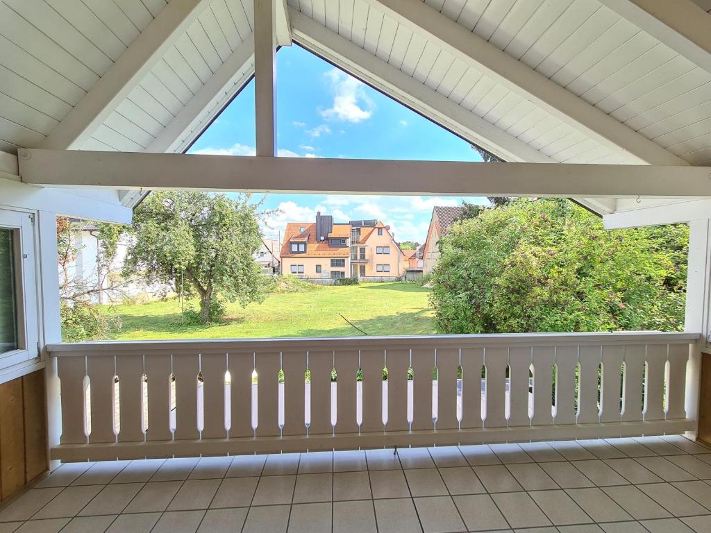 a window on a porch with a view of a house at Haus Mitten in Herzen von Günzburg in Günzburg