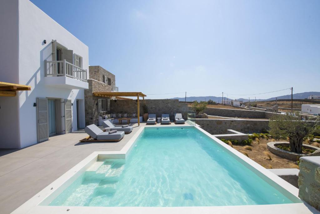 a villa with a swimming pool on a roof at Summer Breeze Luxury Villa Mykonos in Panormos Mykonos