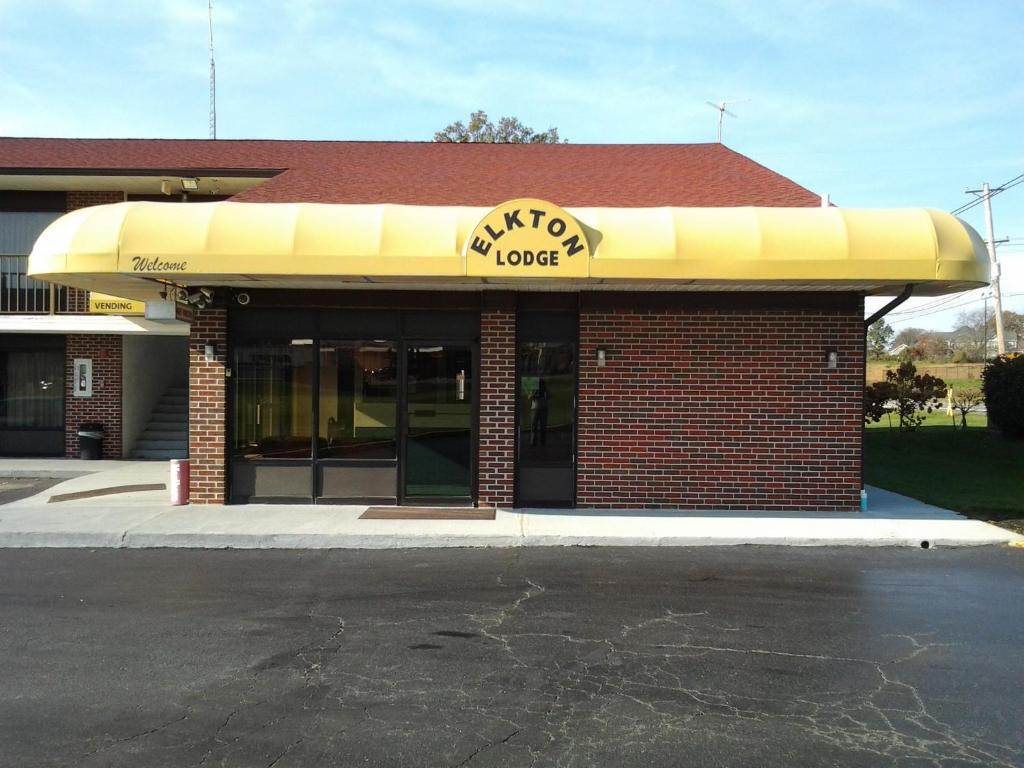 a mcdonalds restaurant with a yellow awning on a building at Elkton Lodge in Elkton