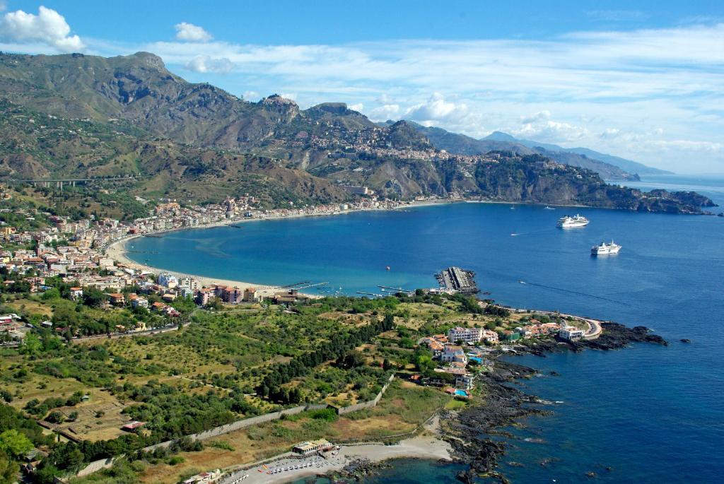 an aerial view of a bay with boats in the water at stanza vista mare in Giardini Naxos