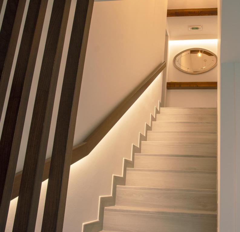 a staircase in a house with wooden railings at Marujita Vilanova, alojamiento singular in Villanueva de Arosa