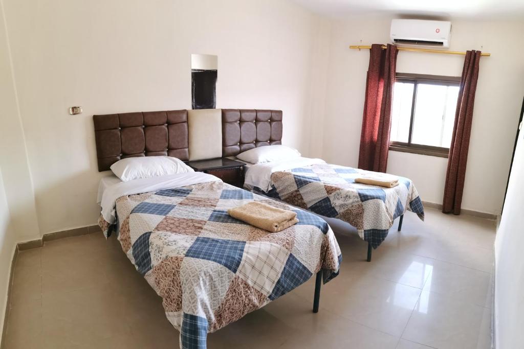 Postel nebo postele na pokoji v ubytování Petra Gate Hotel