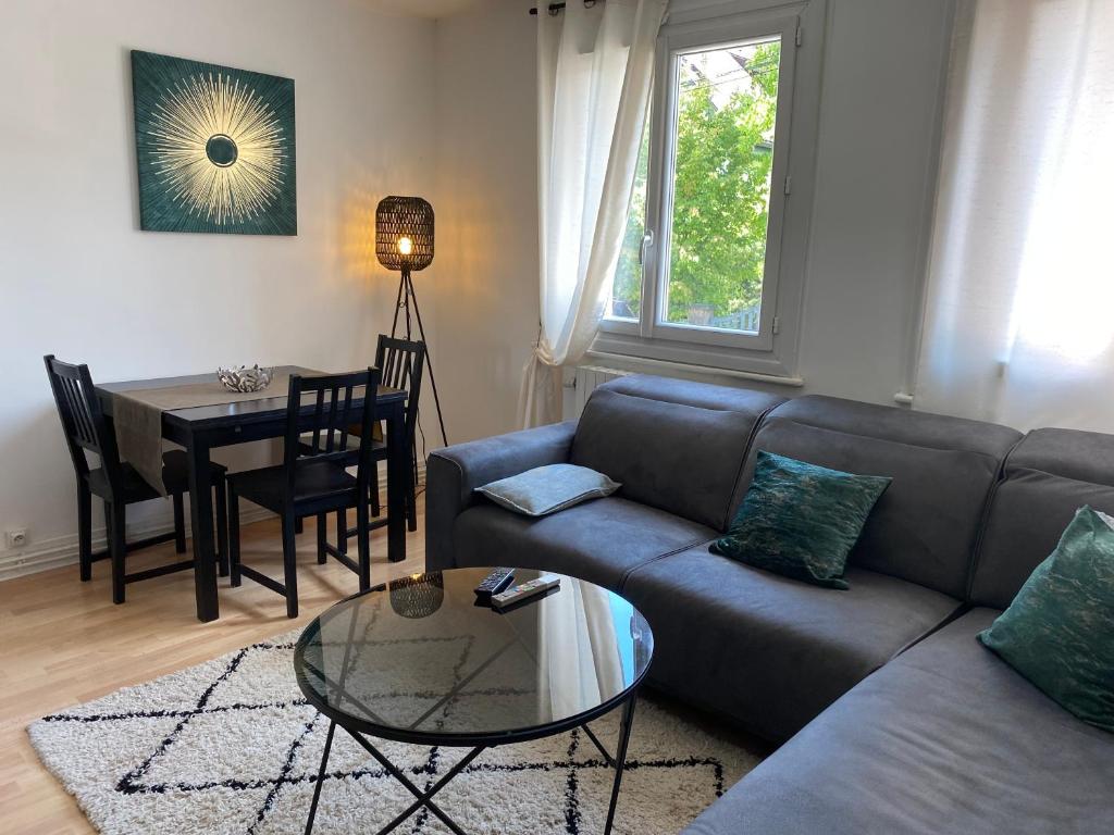 un salon avec un canapé et une table dans l'établissement LA PERLE - Charmant T3 à Annecy, à Annecy