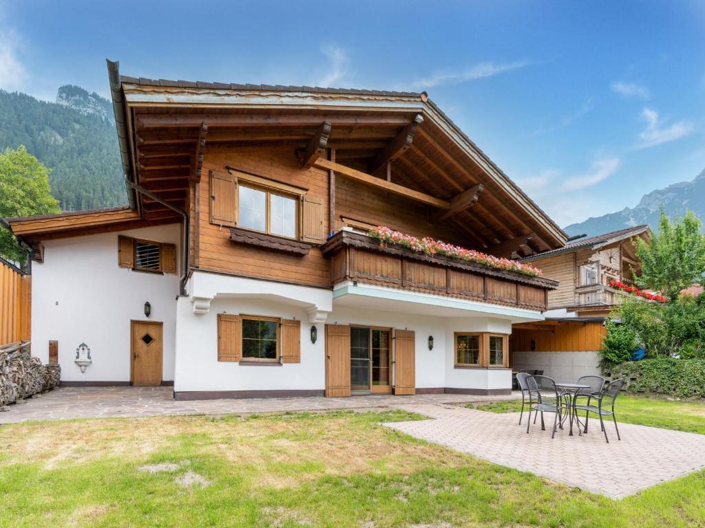 a house in the mountains with a patio at Charming holiday home in Maurach am Achensee in Maurach