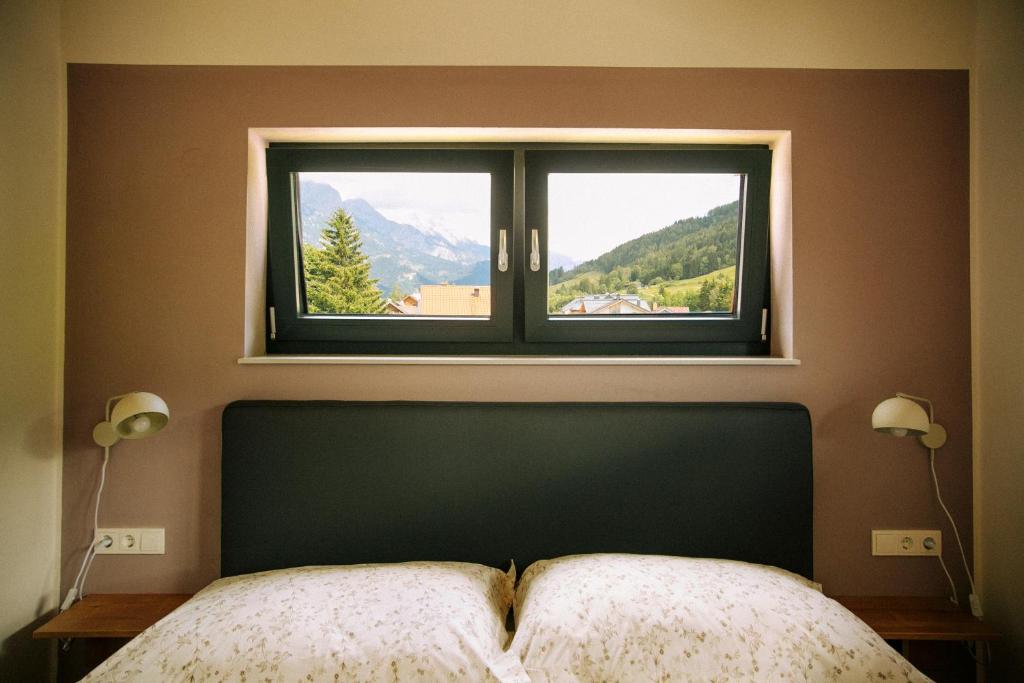 a bedroom with a window with a view of a mountain at Wia dahoam in Leogang