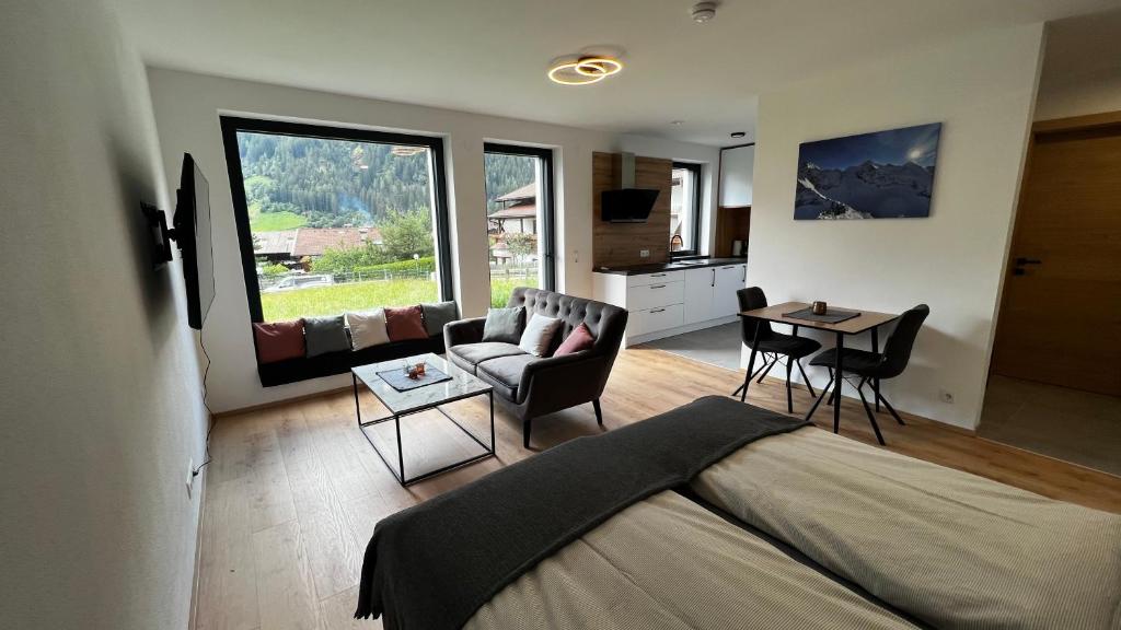a bedroom with a bed and a living room at Studio11 in Neustift im Stubaital
