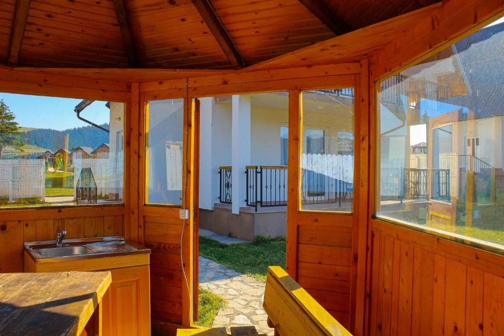 a wooden screened in porch with a sink and windows at Oaza Mira Hotel & Resort-فندق ومنتجع واحة الهدوء in Vlasic