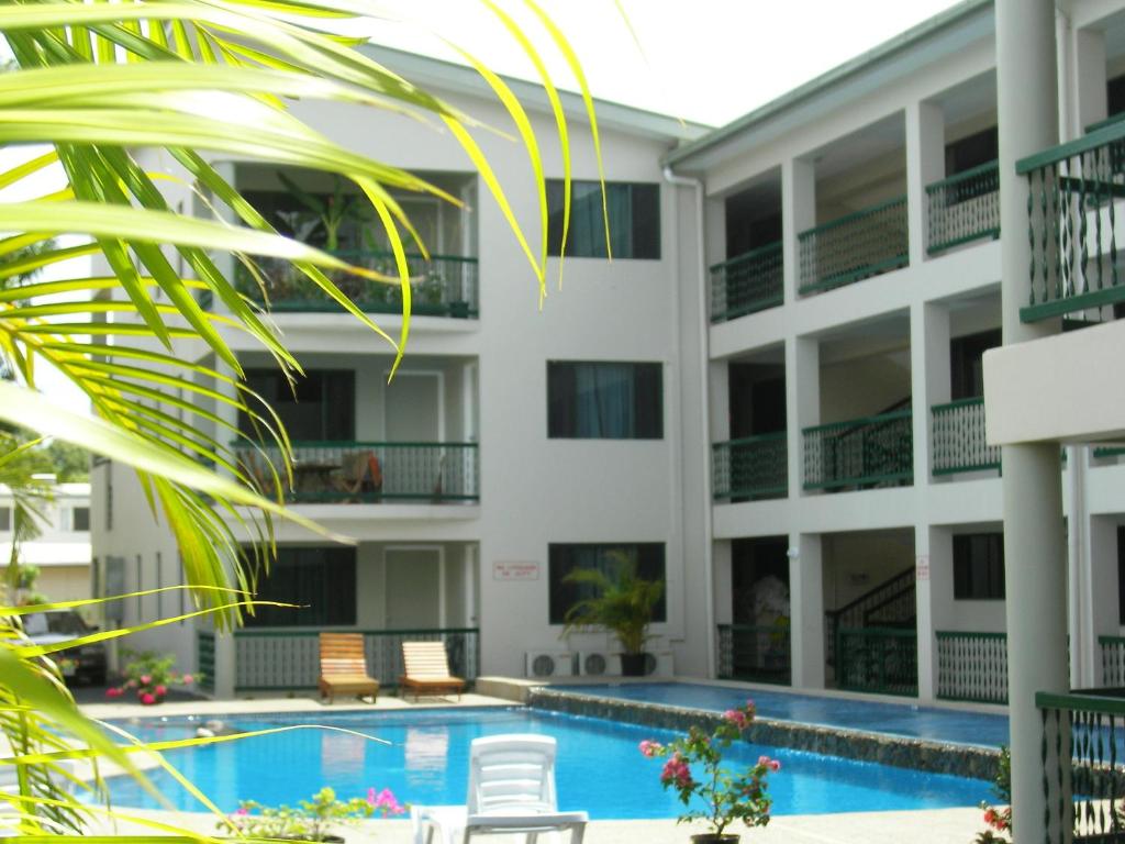 an exterior view of a building with a swimming pool at Hexagon International Hotel, Villas & Spa in Nadi