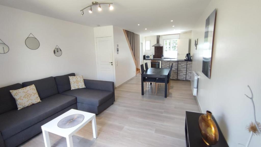 a living room with a couch and a table at Maison de ville centre Nogent le Rotrou in Nogent-le-Rotrou