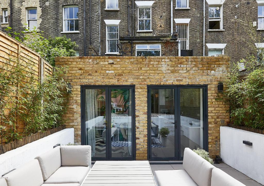 a brick wall with glass doors in front of a building at The Flamingo in London