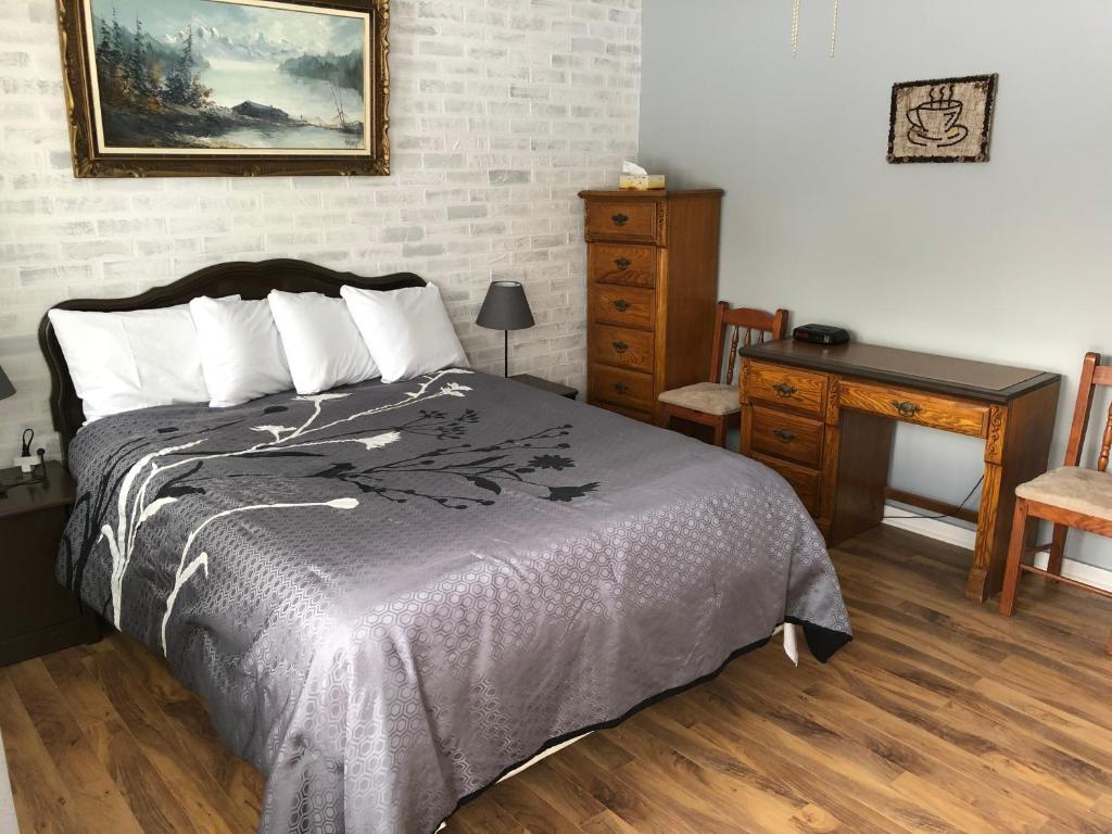 Postel nebo postele na pokoji v ubytování Auberge Restwell Motel