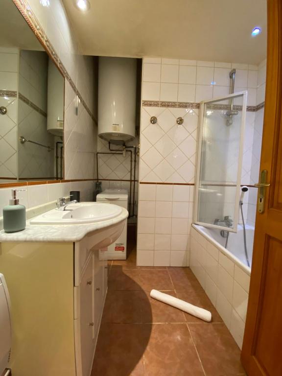 a bathroom with a sink and a shower and a tub at LEtage - Large T3 in the heart of the Old Town of Annecy in Annecy