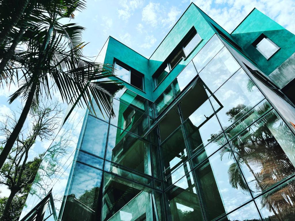 a glass building with a sign on it at Emerald House in Rio de Janeiro