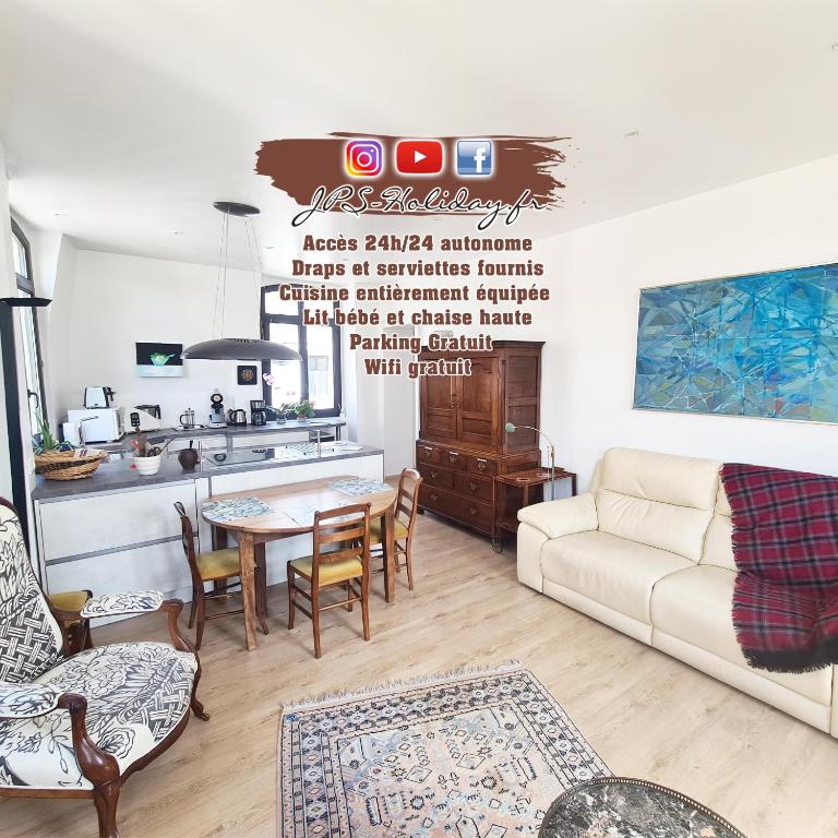 a living room with a couch and a table at Le Phare Dieppois by JPS Holiday - Chaleureux appartement au cœur de Dieppe in Dieppe
