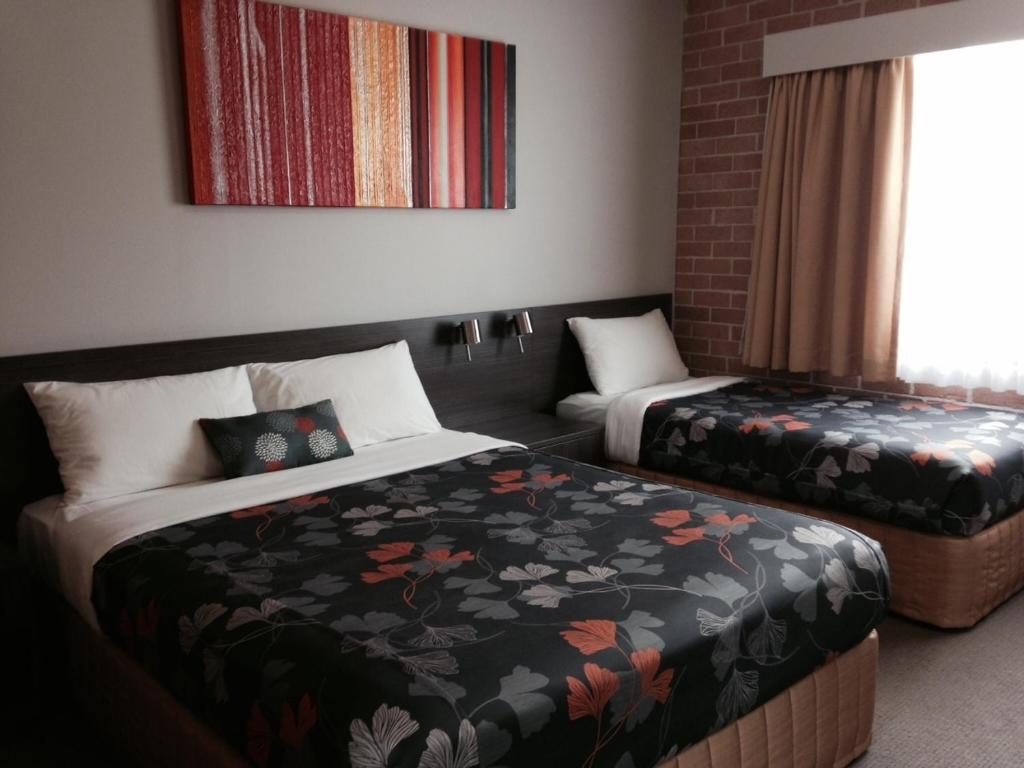Ένα ή περισσότερα κρεβάτια σε δωμάτιο στο Alexander The Great Motel
