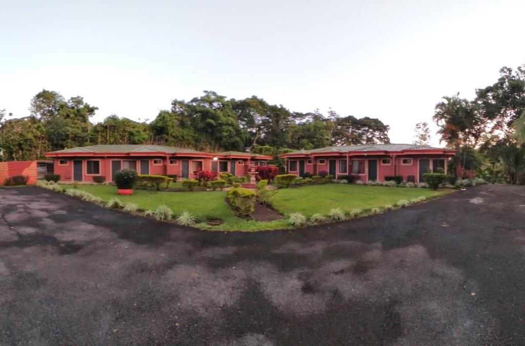 a row of red houses in a parking lot at Regenerate Wellness Center at Villas Escondidas in Grecia