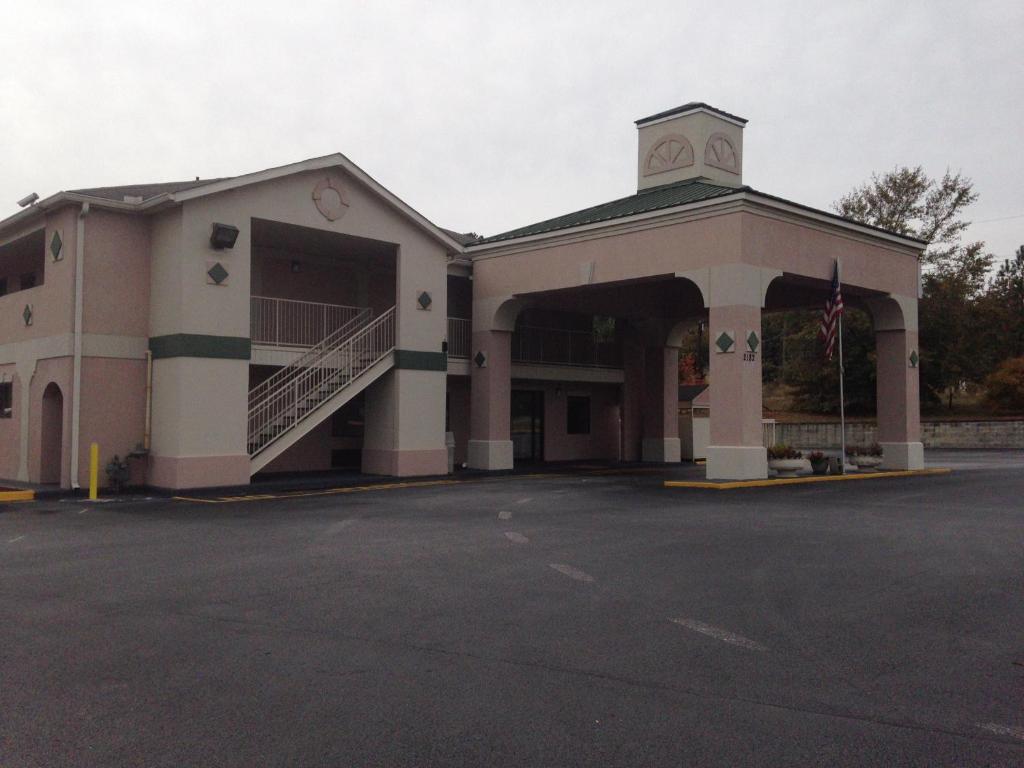 a building with a parking lot in front of it at Country Hearth Inn & Suites Augusta in Augusta