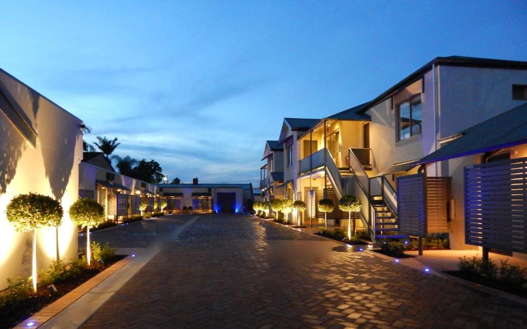 an empty street at night with buildings and lights at North Adelaide Boutique Stays Accommodation in Adelaide