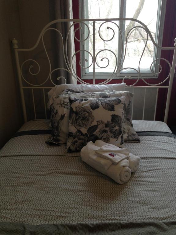 ręcznik siedzący na łóżku obok okna w obiekcie Montreal Downtown Suite w Montrealu