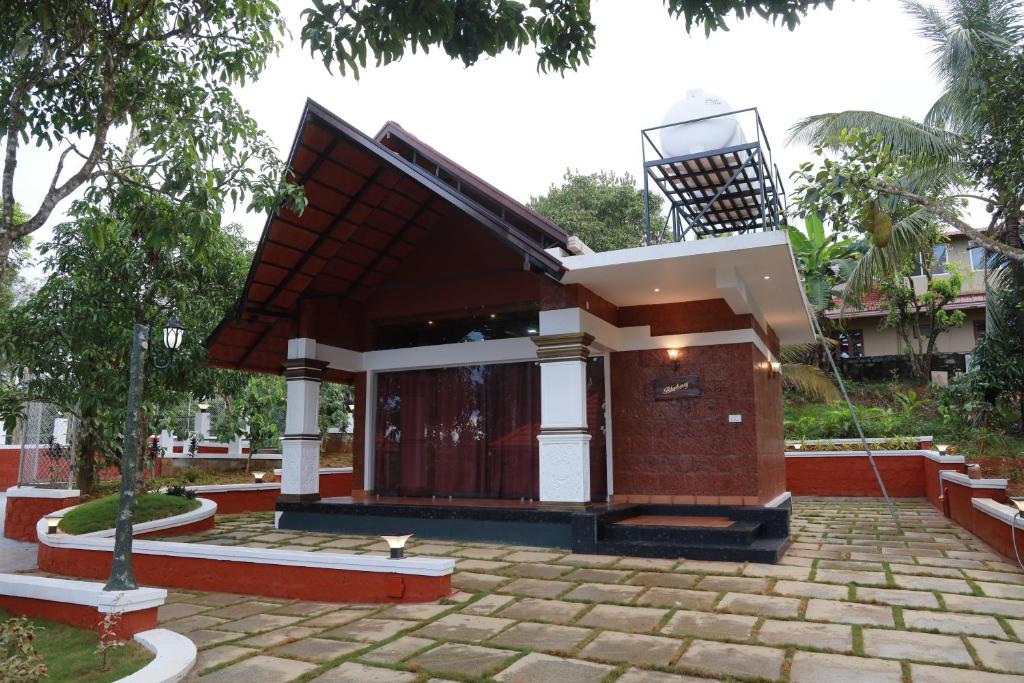 a small house with a red at Miracle Holidays in Mananthavady