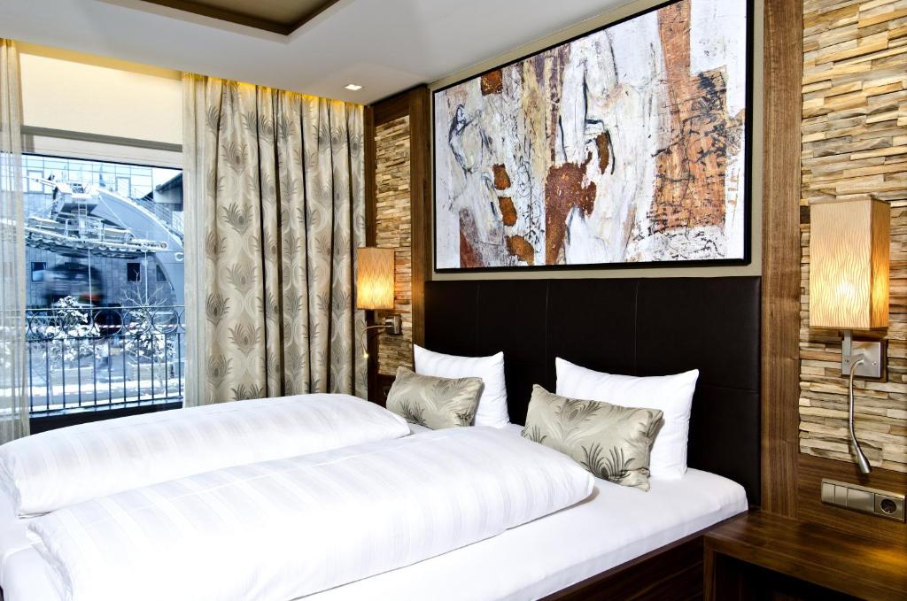 Postel nebo postele na pokoji v ubytování Hotel Garni Astoria