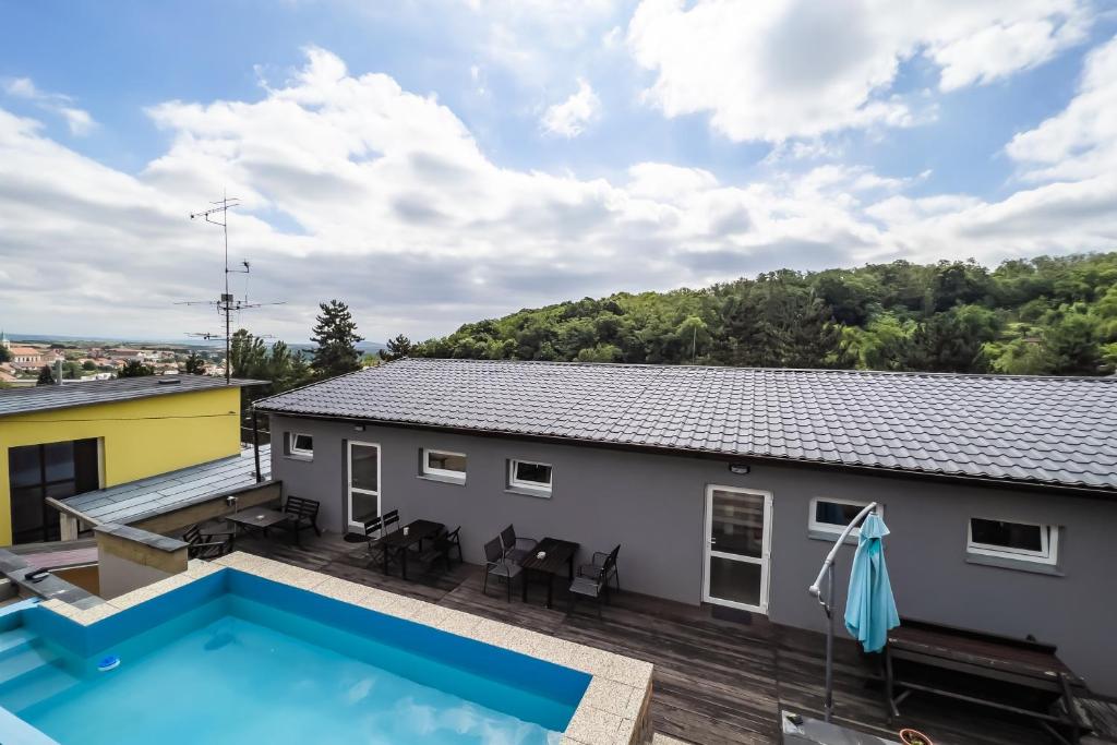 a view of the backyard of a house with a swimming pool at Apartmán u lesa in Klobouky u Brna