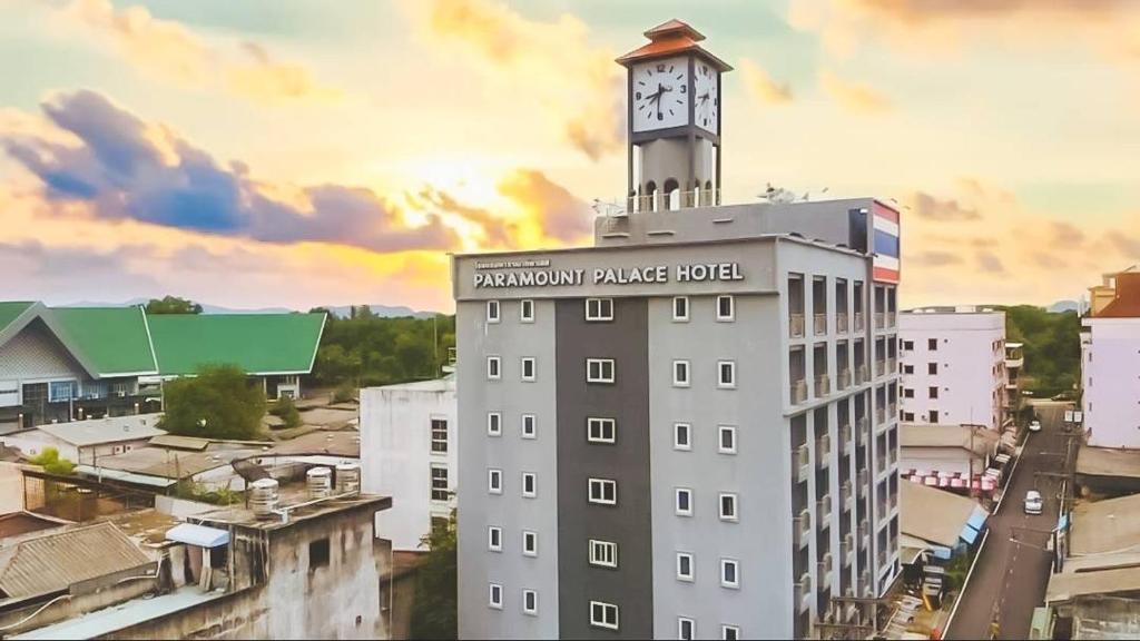 a building with a clock tower on top of it at Paramount Palace Hotel Dannok in Sadao
