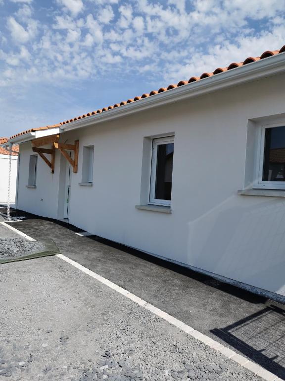 une maison blanche avec un toit dans l'établissement Maison Proche Centre Ville, à Biscarrosse