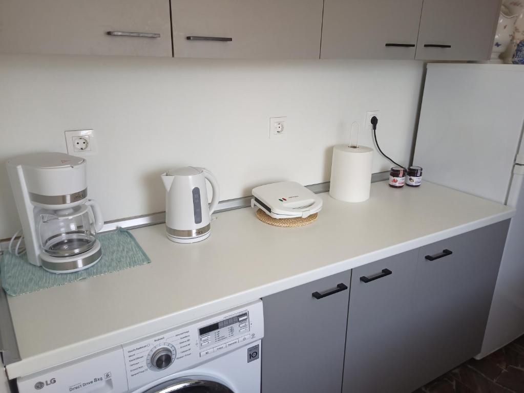 a kitchen with a white counter top with a appliance at Casa Con Vista Apartments in Halki