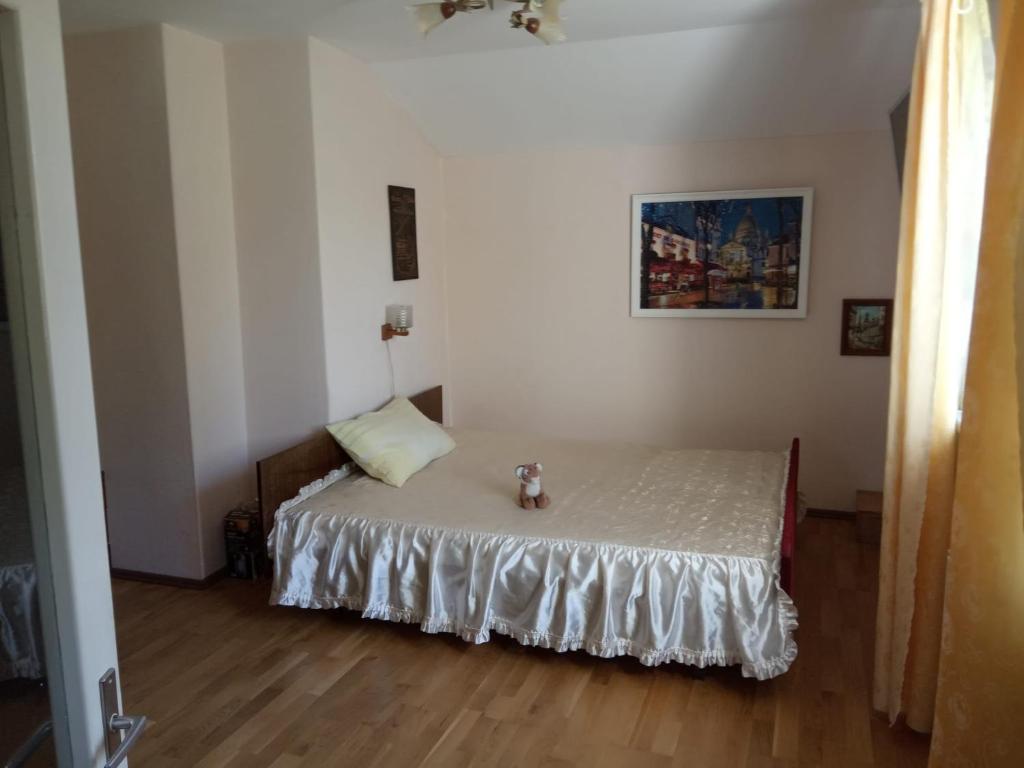 a bedroom with a bed with a teddy bear on it at Apartment in Kauguri in Jūrmala