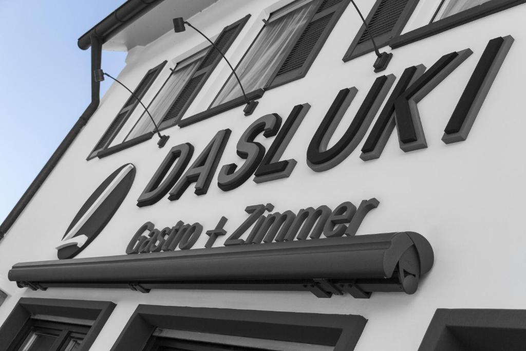a sign for a restaurant on the side of a building at Dasluki in Köngen