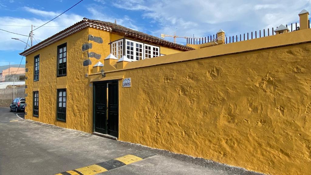 ein gelbes Gebäude mit einer Seitentür in der Unterkunft Casa Rural La Gañanía in Los Realejos
