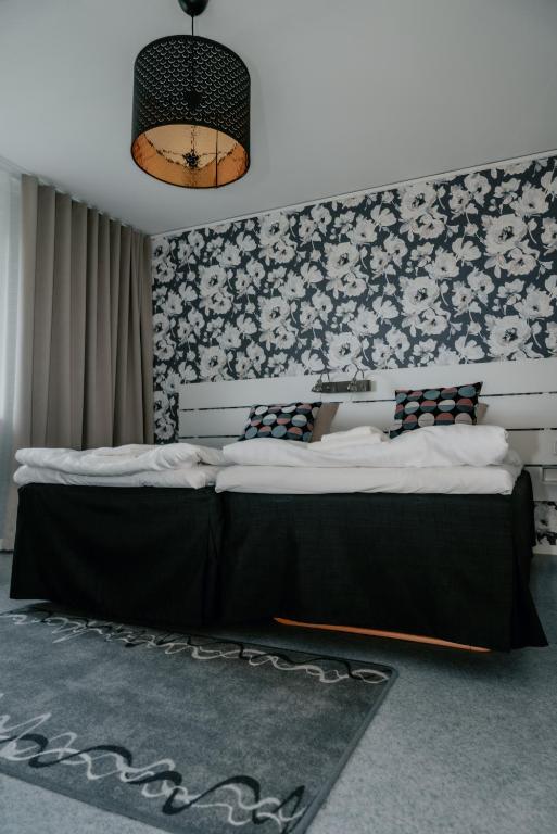 Postel nebo postele na pokoji v ubytování Wisingsö Hotell