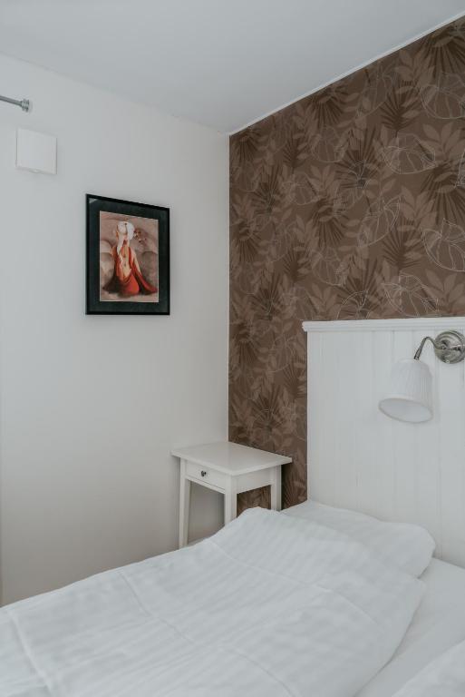 Postel nebo postele na pokoji v ubytování Wisingsö Hotell