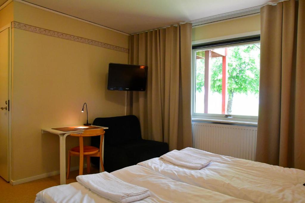 Postel nebo postele na pokoji v ubytování Wisingsö Hotell