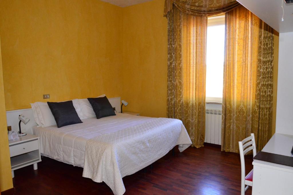 Postel nebo postele na pokoji v ubytování Hotel Altavilla