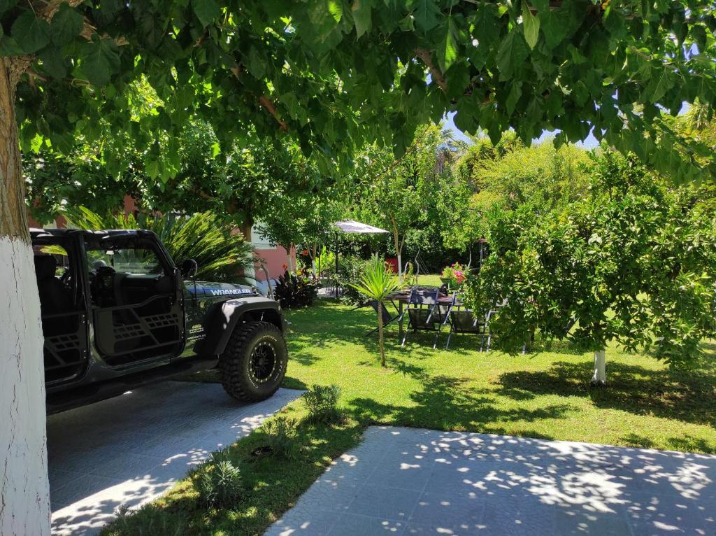 a truck parked in a yard with a table and chairs at Aurora Premium Hospitality in Parga