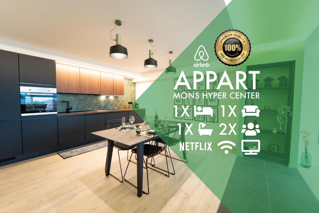 una cucina con tavolo e parete verde di Green Appart - A&B Best Quality - Mons City Center a Mons