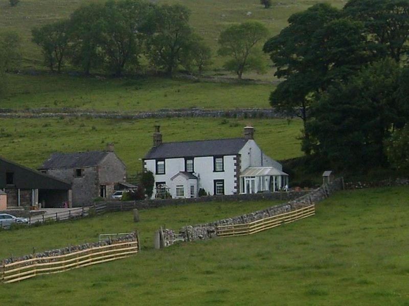 a white house in the middle of a field at Fernydale Farm Bed & Breakfast in Earl Sterndale