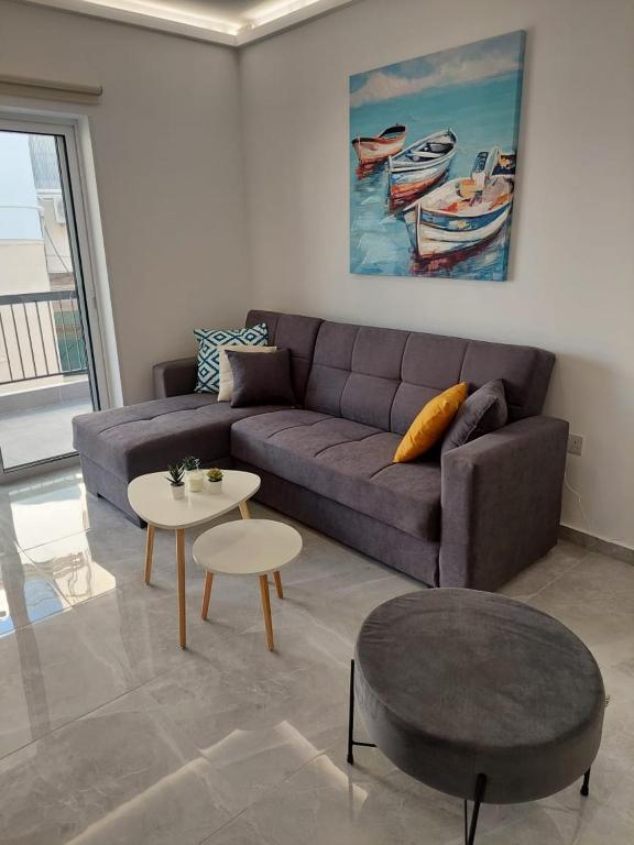 a living room with a couch and a table at Amazing Napa Apartment in Ayia Napa