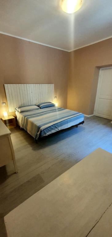 a bedroom with a large bed in a room at Casa del trogolo in Varazze