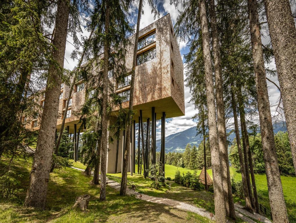 a building in the middle of trees at My Arbor - Plose Wellness Hotel in Bressanone
