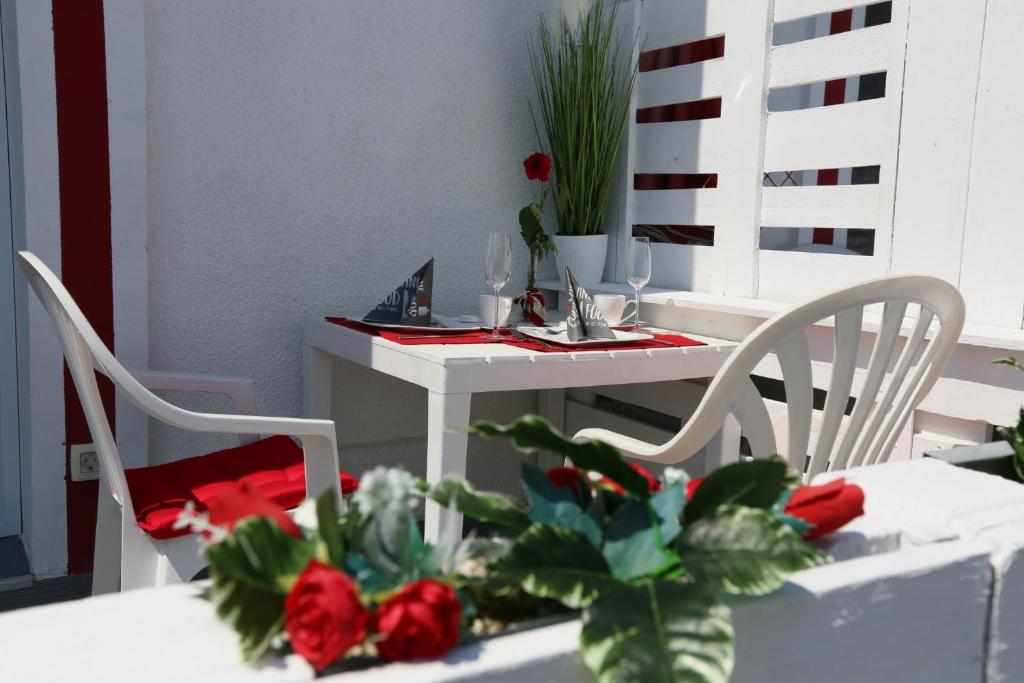 een tafel met twee stoelen en een tafel met rozen erop bij EHM Resort Mesteri in Mesteri