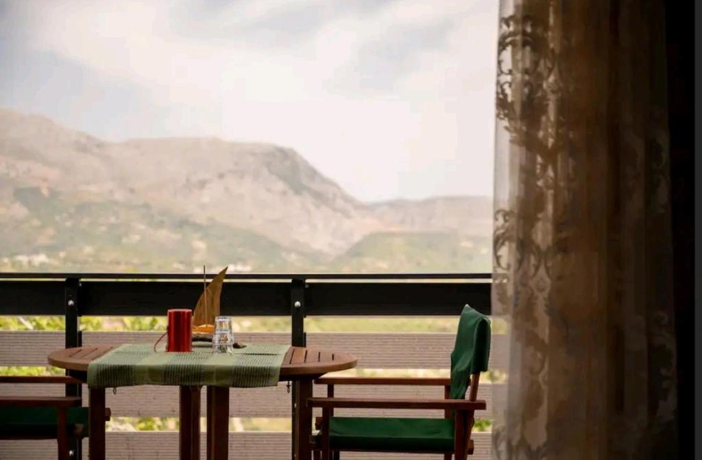 a table and chairs with a view of a mountain at Dioni Stone House in Petrokefalo