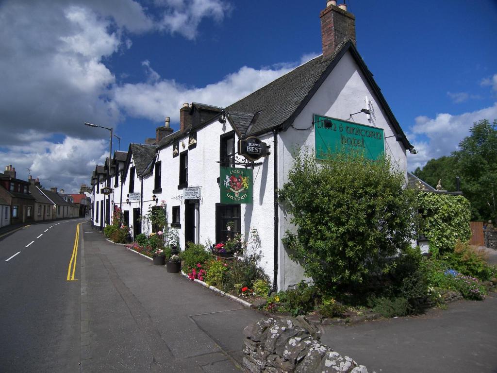 a row of white buildings on the side of a street at Lion and Unicorn Hotel in Thornhill