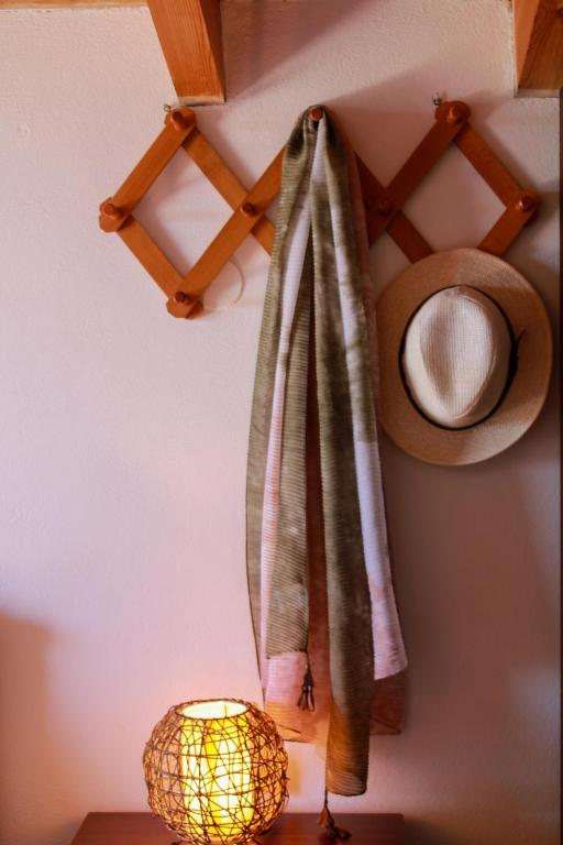 a towel hanging on a wall next to a lamp at Giovanni Group Apartments in Syvota