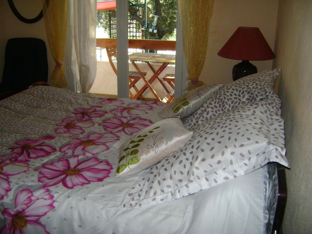 a bedroom with a bed with pillows and a window at Gite à Bandol in Bandol