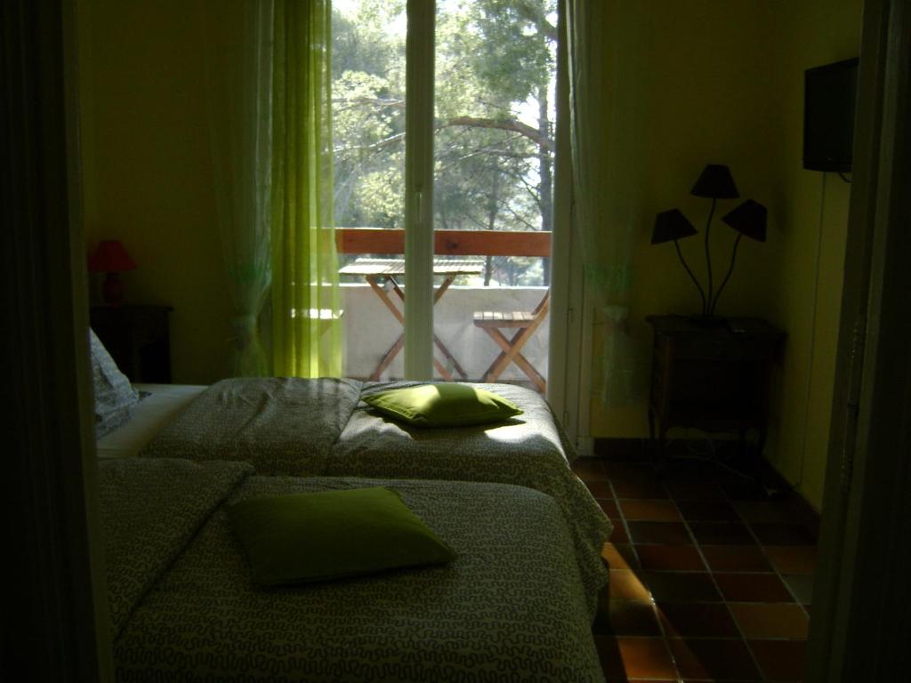 a bedroom with a bed and a large window at Gite à Bandol in Bandol