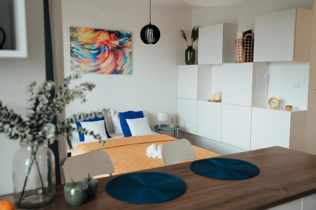 a bedroom with two beds and a wooden table at Blue_Loft in Sandomierz