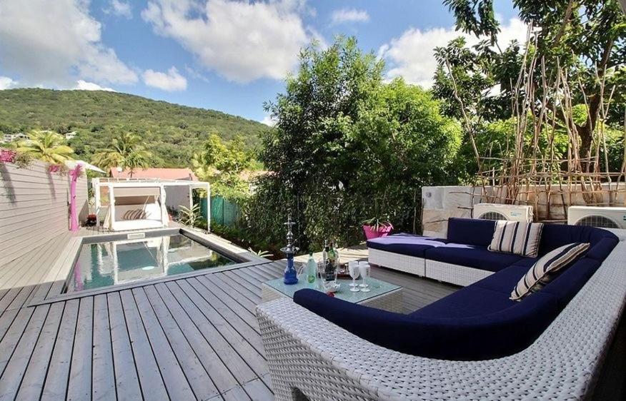 un patio con sofá, mesa y piscina en Eden Sea Villa, en Pointe-Noire